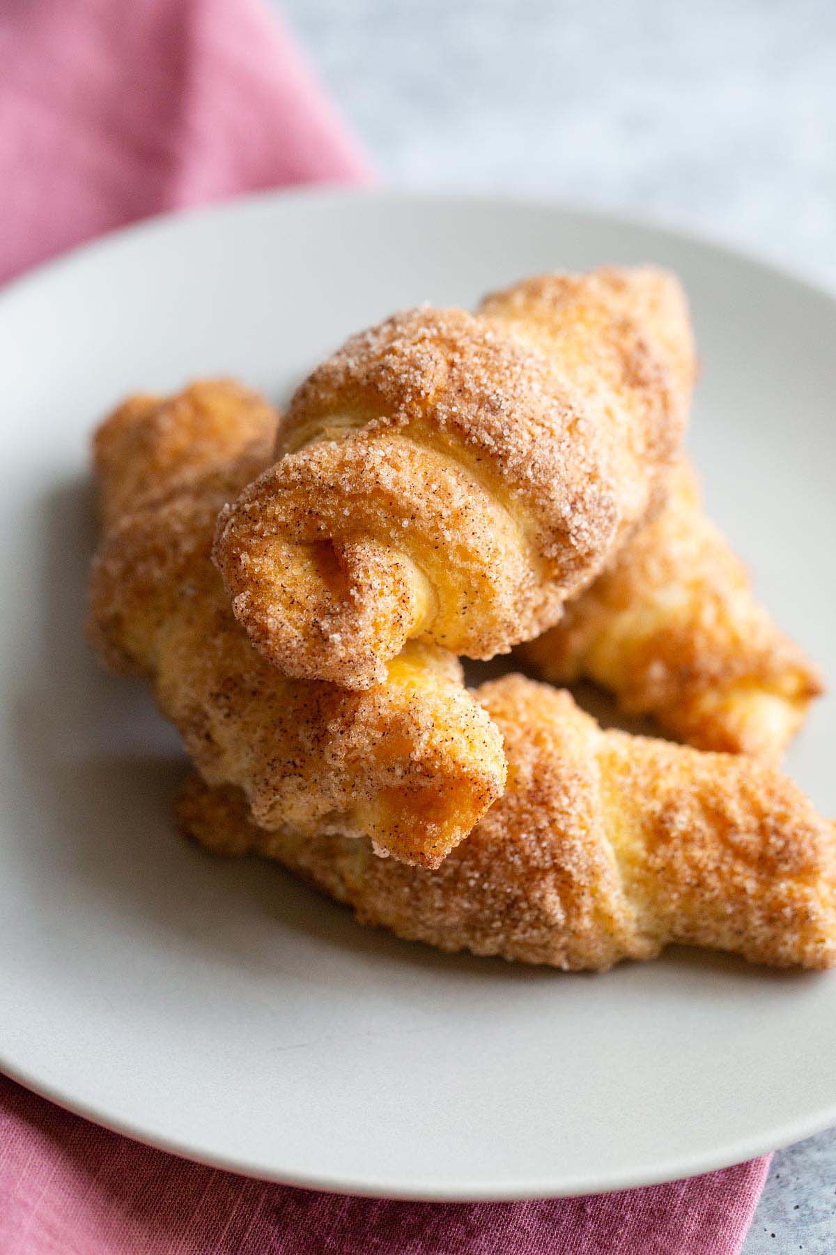 Stacked cinnamon sugar croissants.