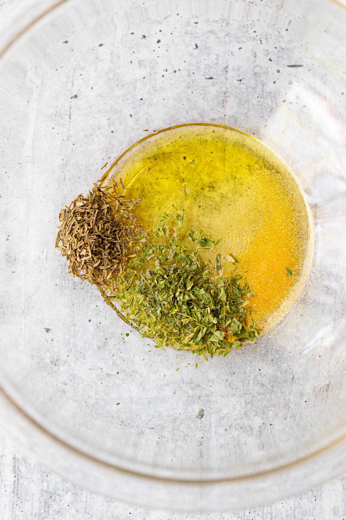 Herbs and olive oil in a bowl.