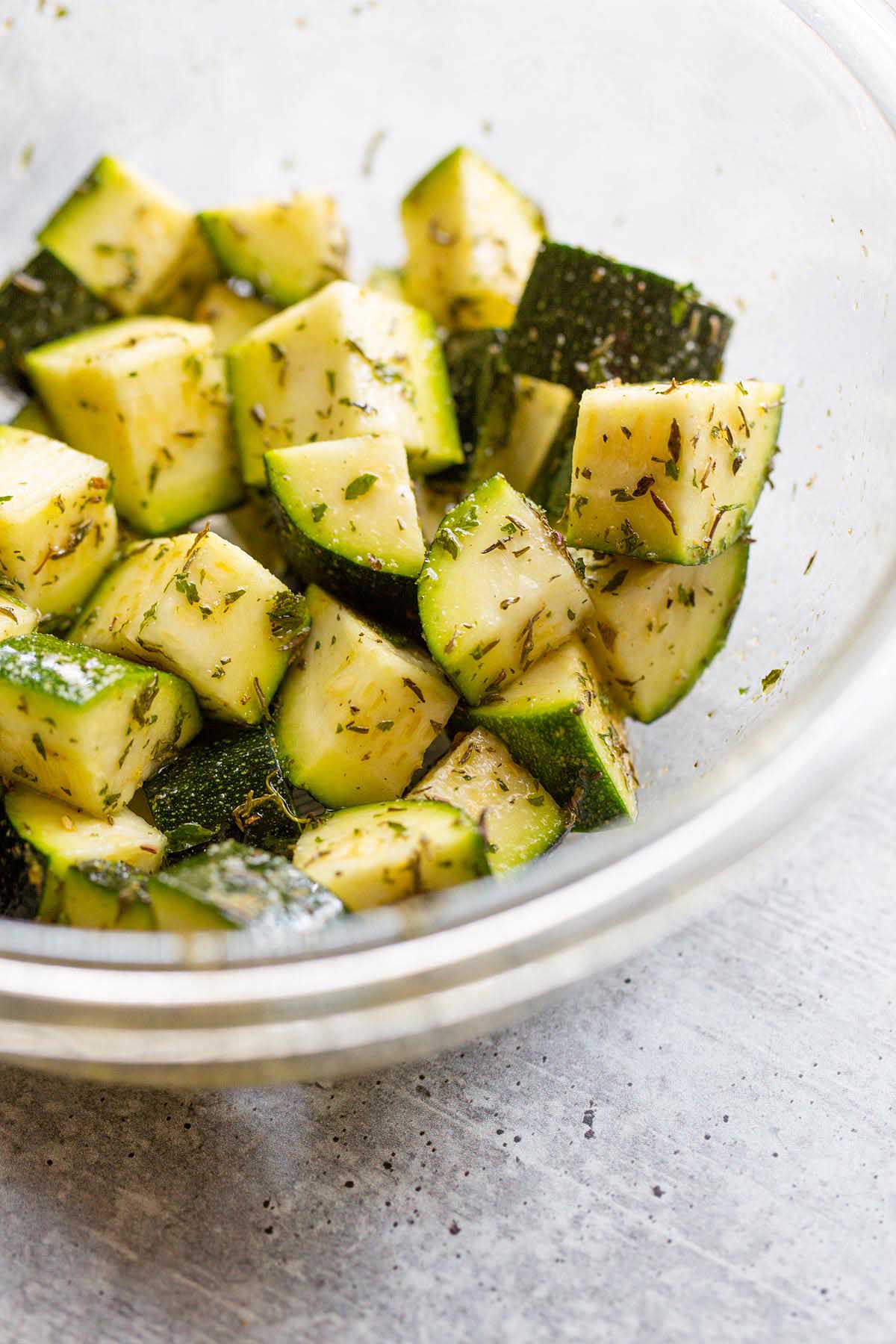 Raw zucchini in a glass bowl.