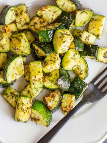 Garlic herb zucchini on a plate.