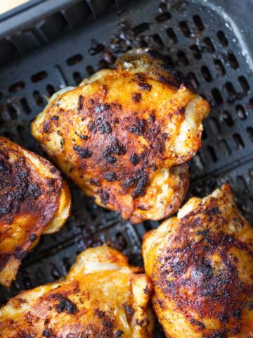 Cooked chicken thighs in the air fryer.