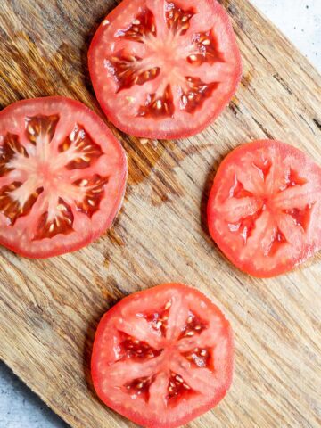 Tomato slices on a cutting board.