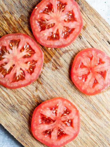 Tomato slices on a cutting board.