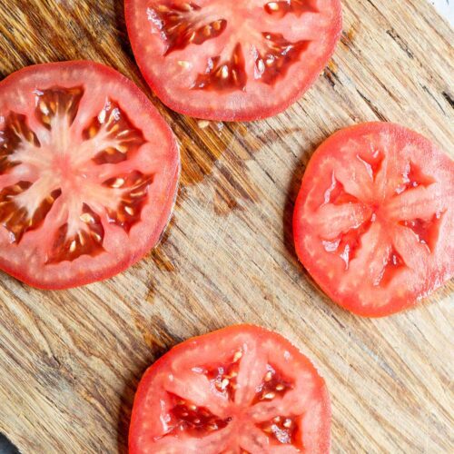 Tomato slices on a cutting board.