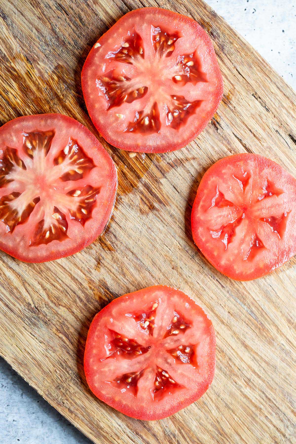 Tomato slices on a cutting board.