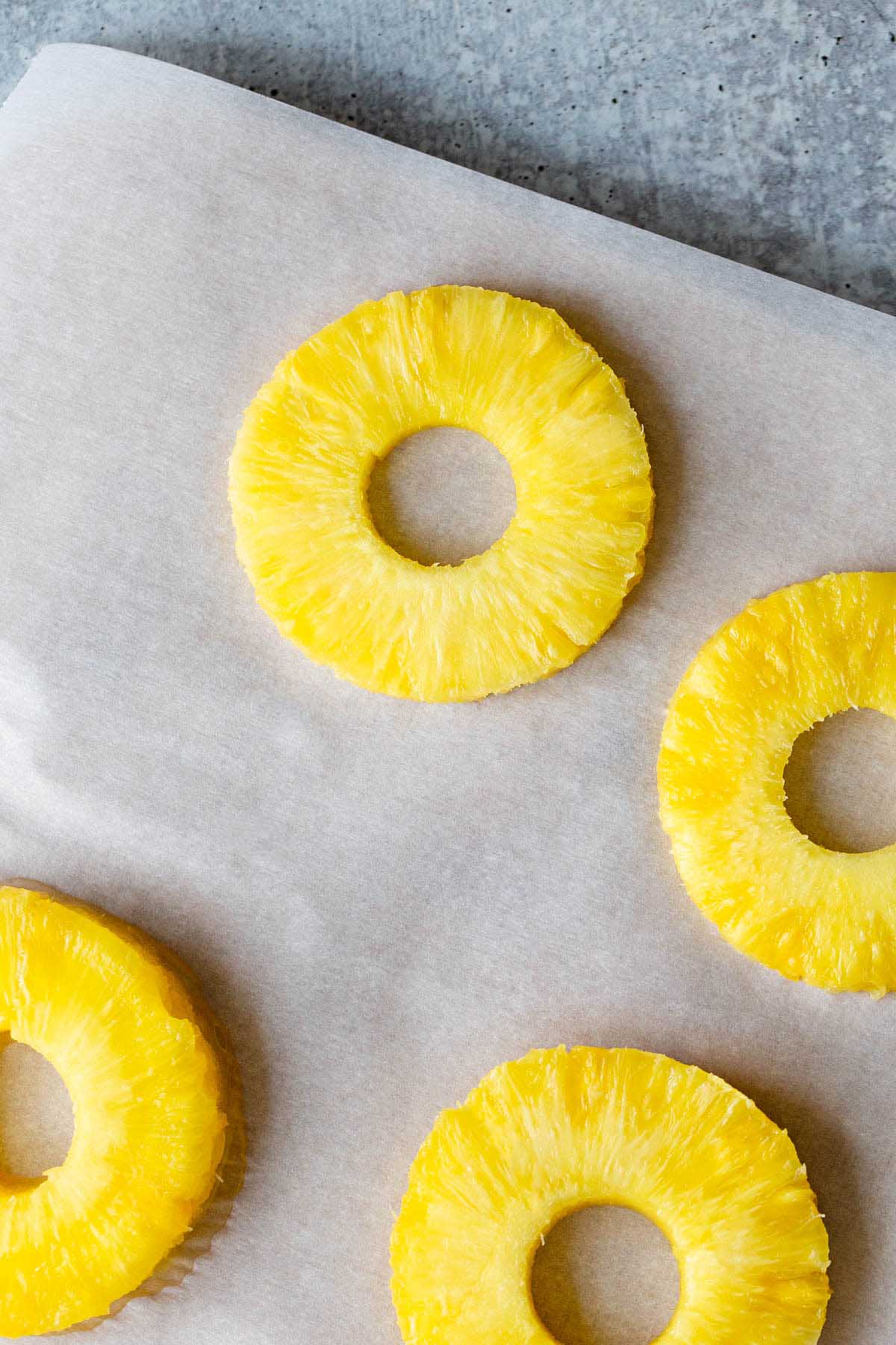Pineapple rings on parchment paper.