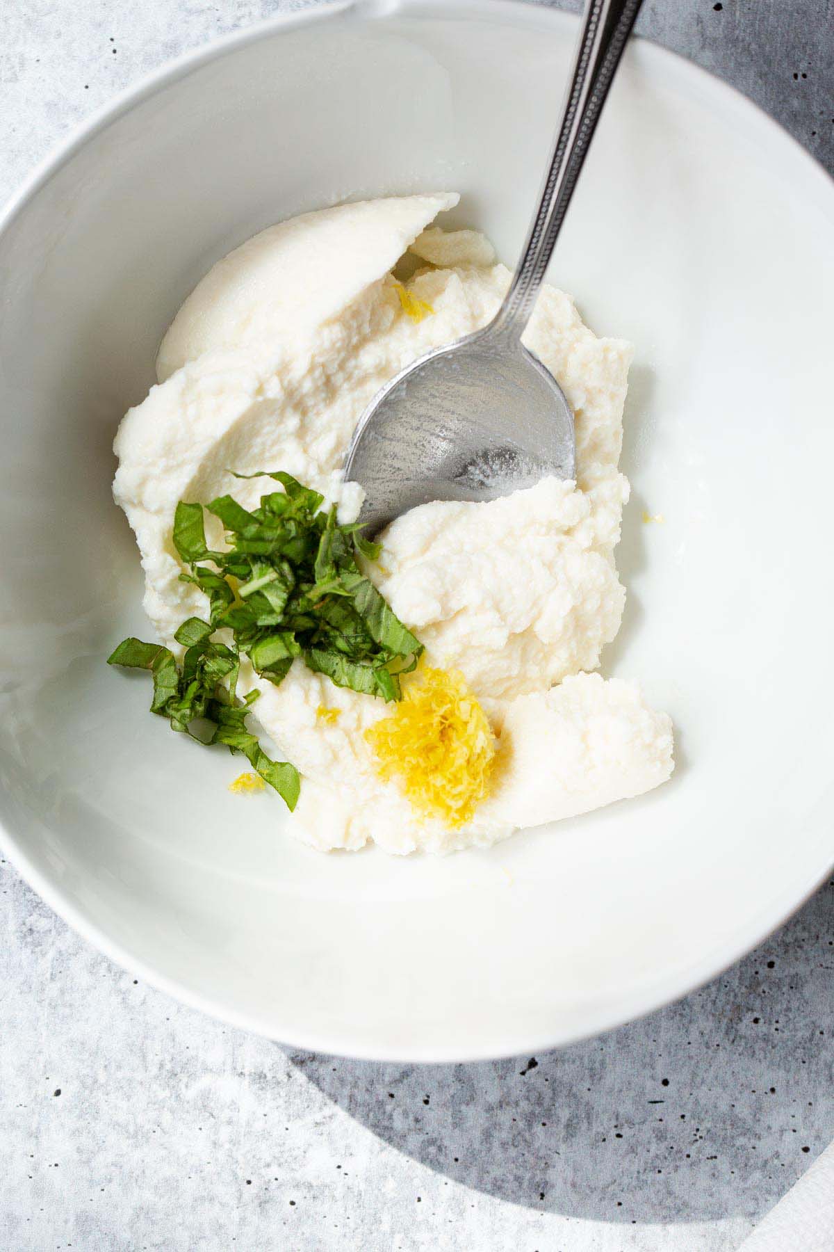 Ricotta with basil and lemon zest.