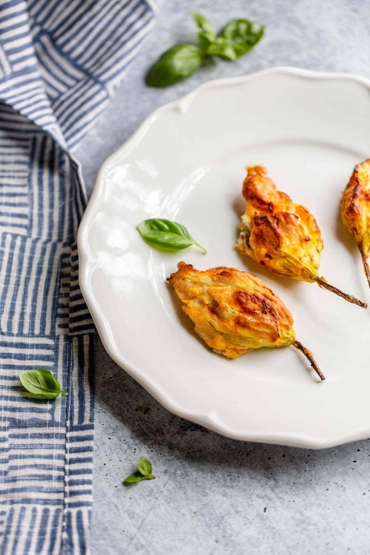 Stuffed Zucchini blossoms on a plate.