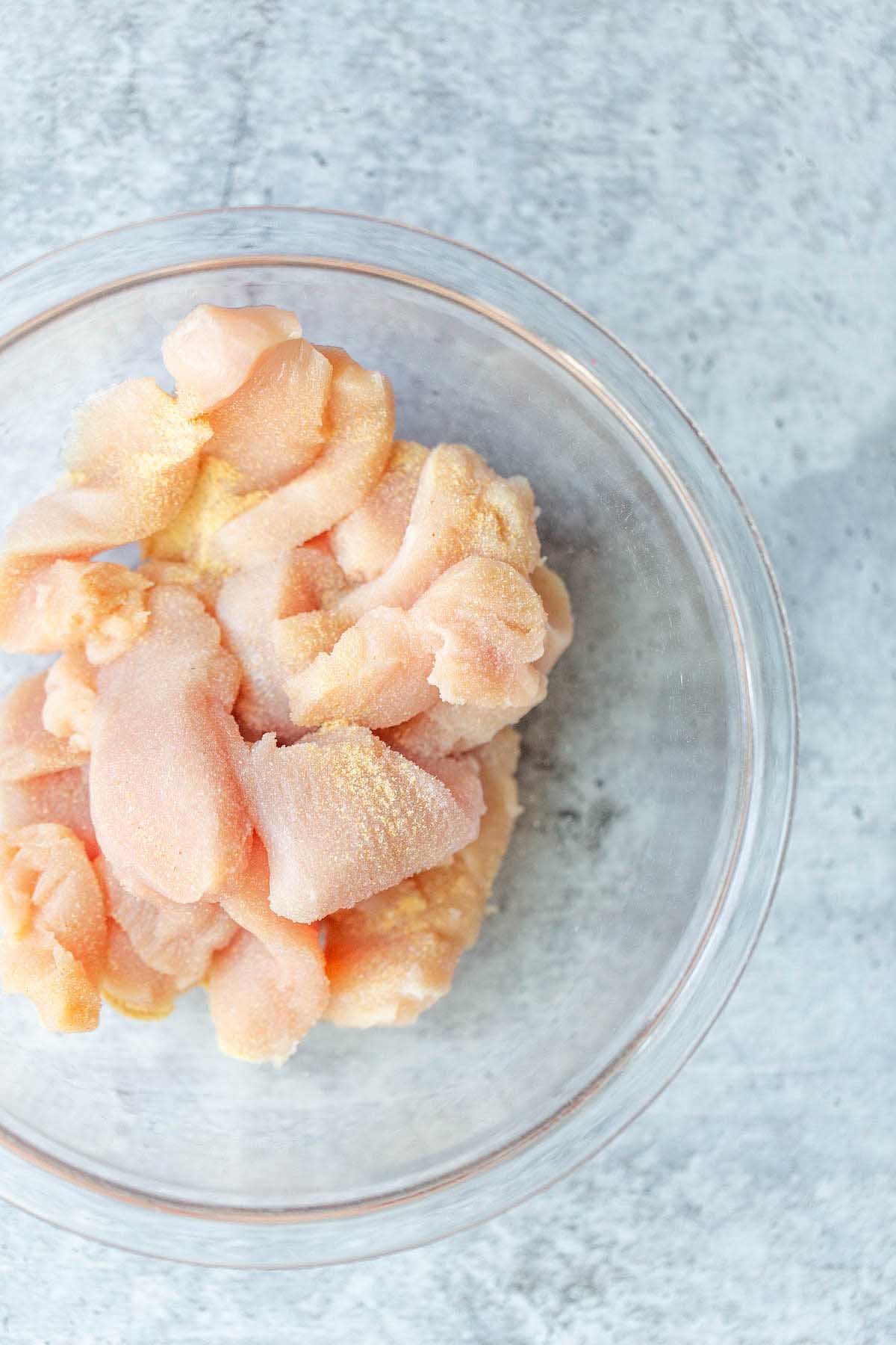 Diced chicken in a glass bowl.