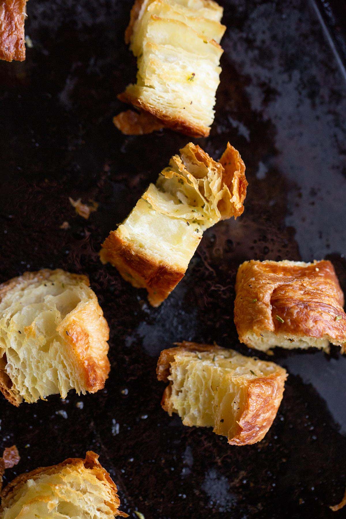 Cooked croutons on a cookie sheet.