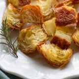rosemary croissant croutons with a sprig of rosemary