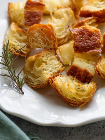 rosemary croissant croutons with a sprig of rosemary