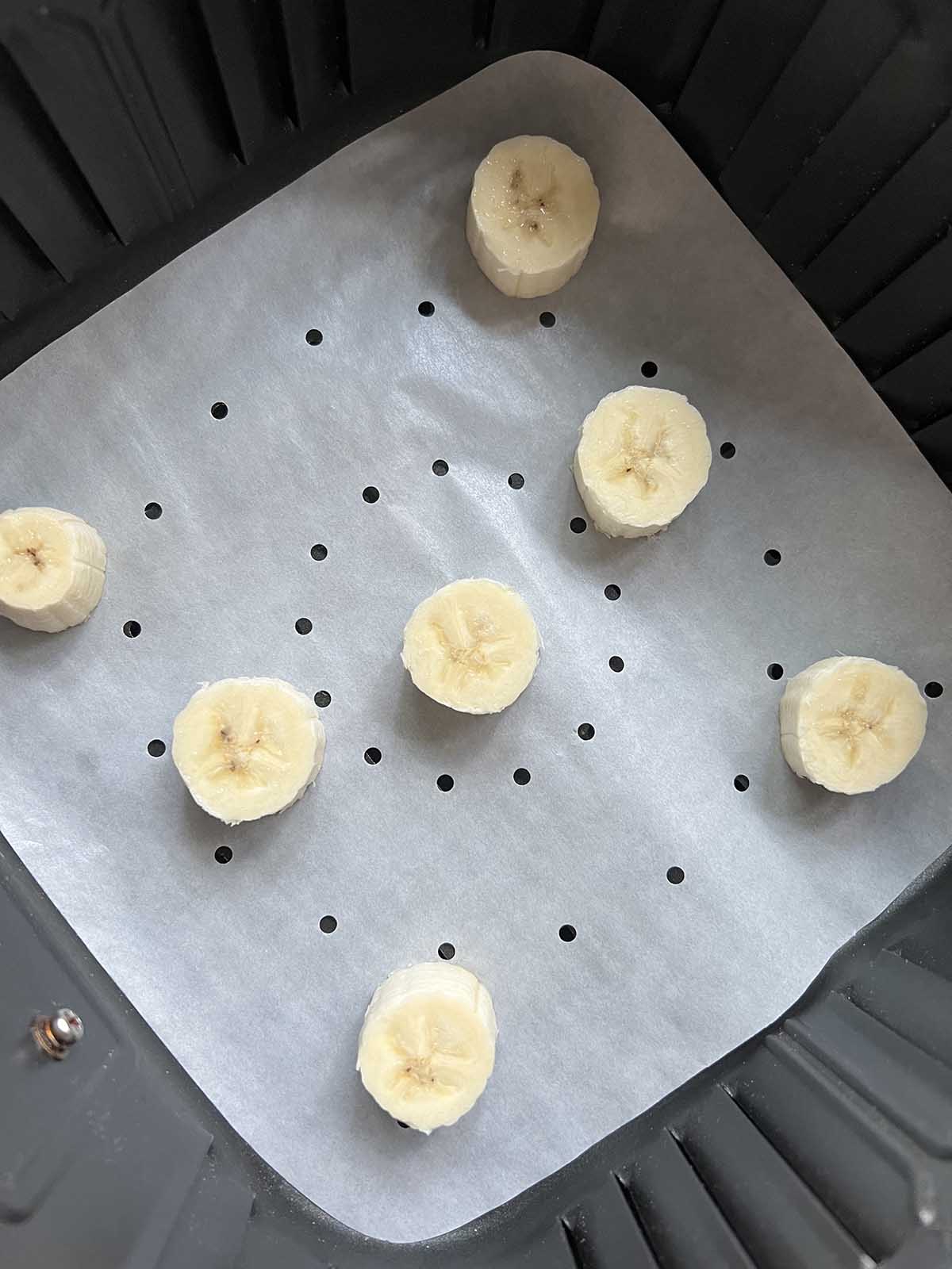 Banana slices in air fryer basket