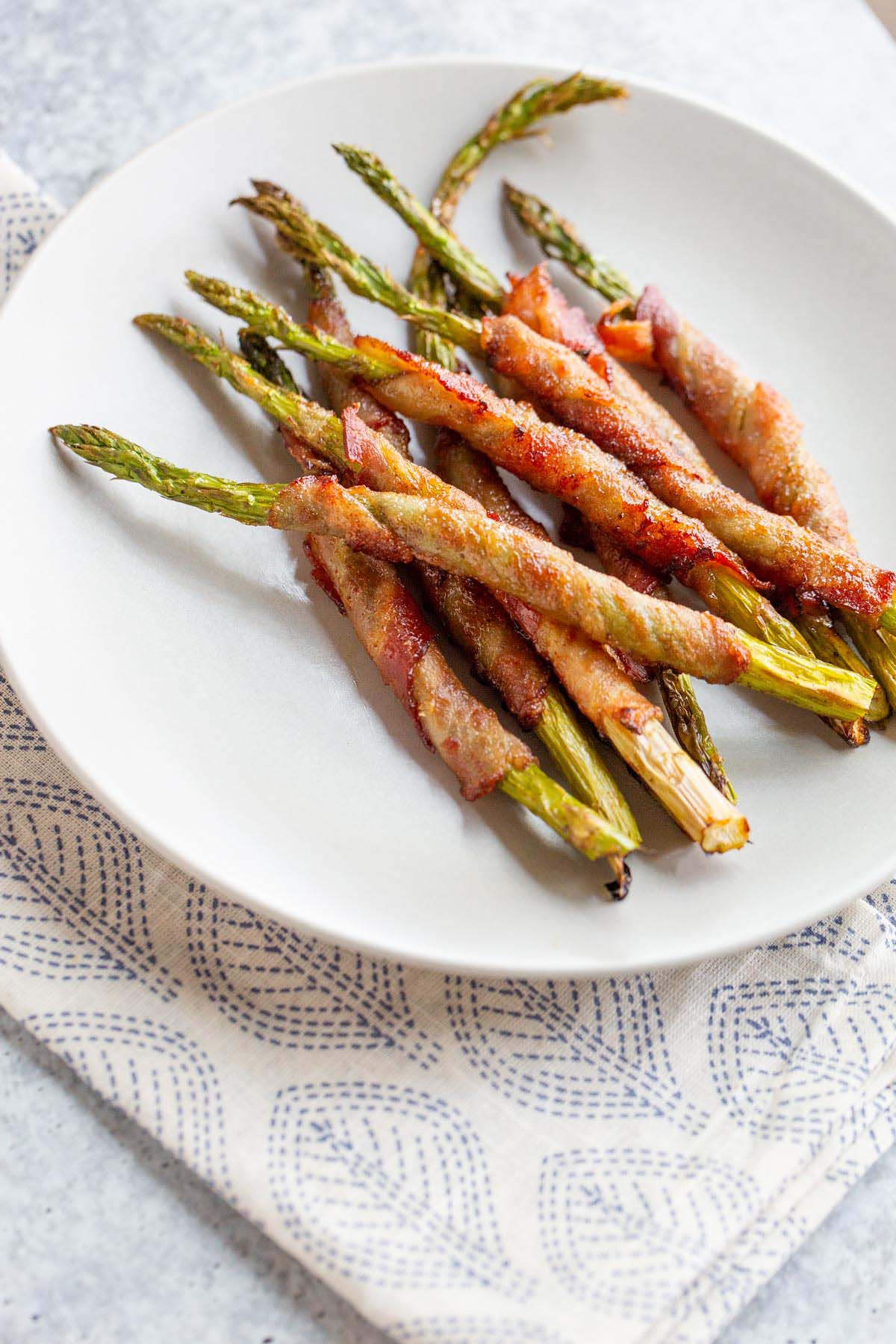 Bacon wrapped asparagus on a plate.