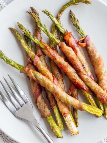 Bacon wrapped asparagus on a plate.