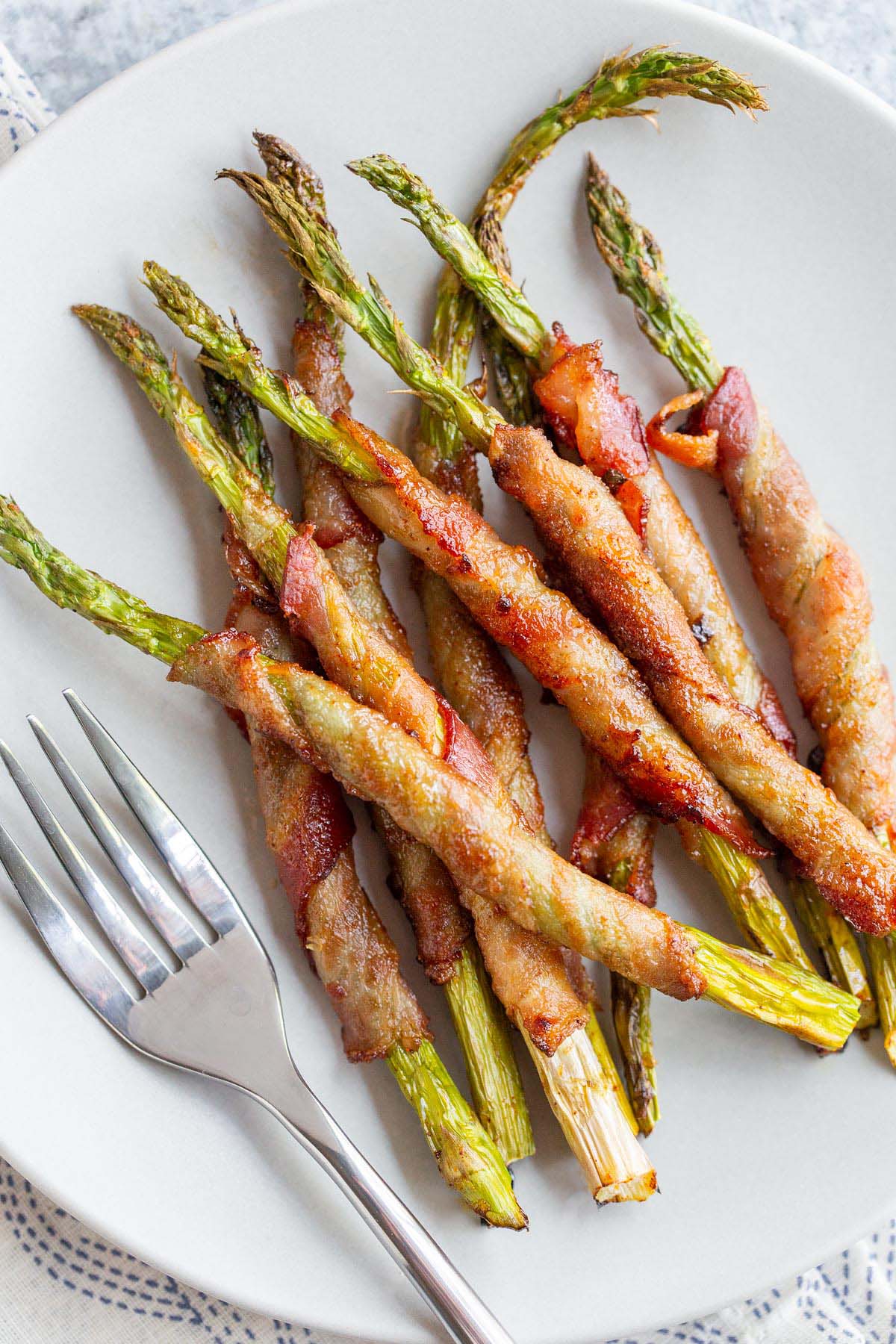 Bacon wrapped asparagus on a plate.