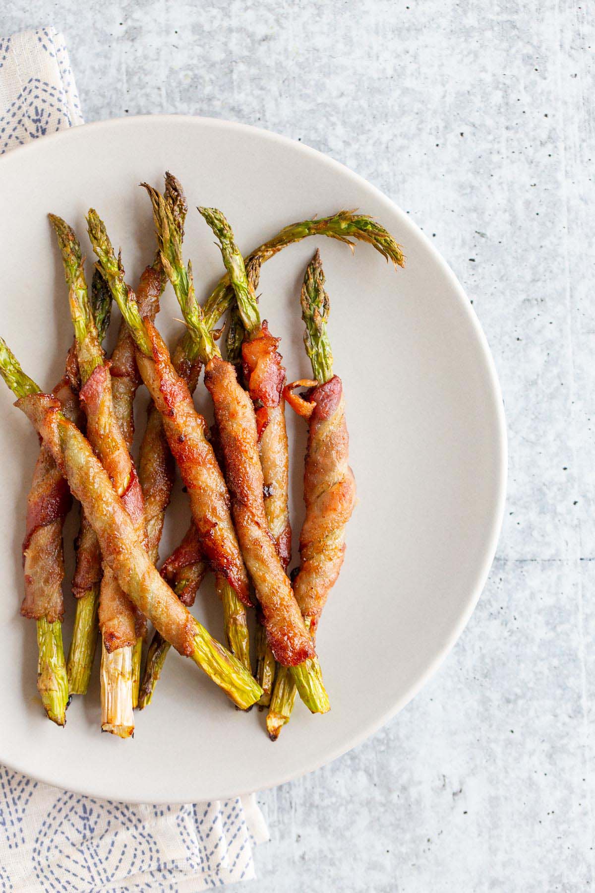 Bacon wrapped asparagus on a plate.