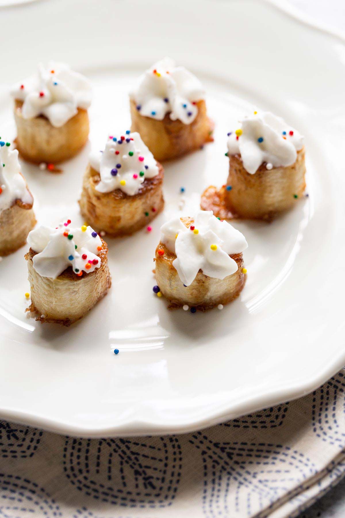 Banana bites with whipped cream and sprinkles