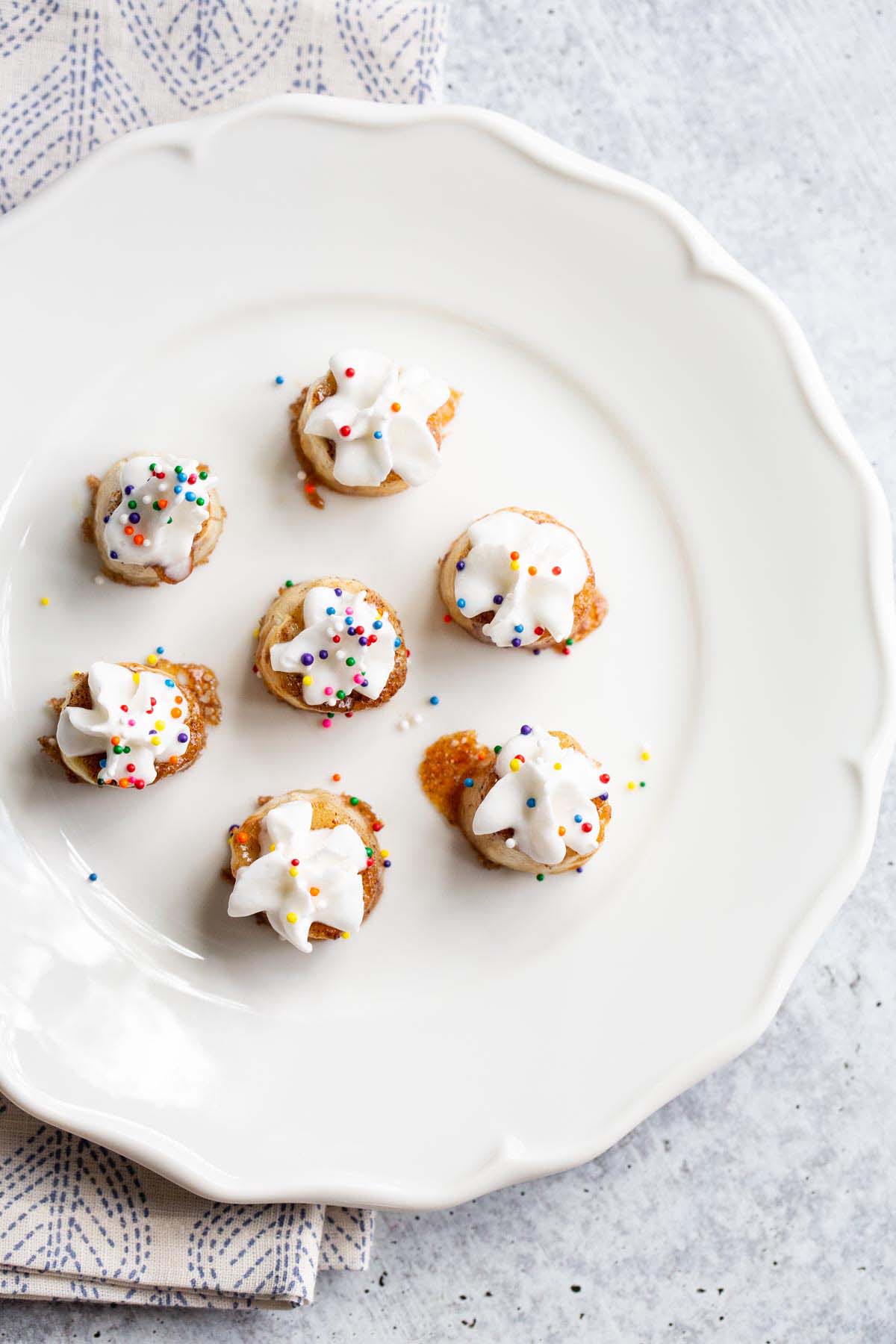 Banana bites with whipped cream and sprinkles from above