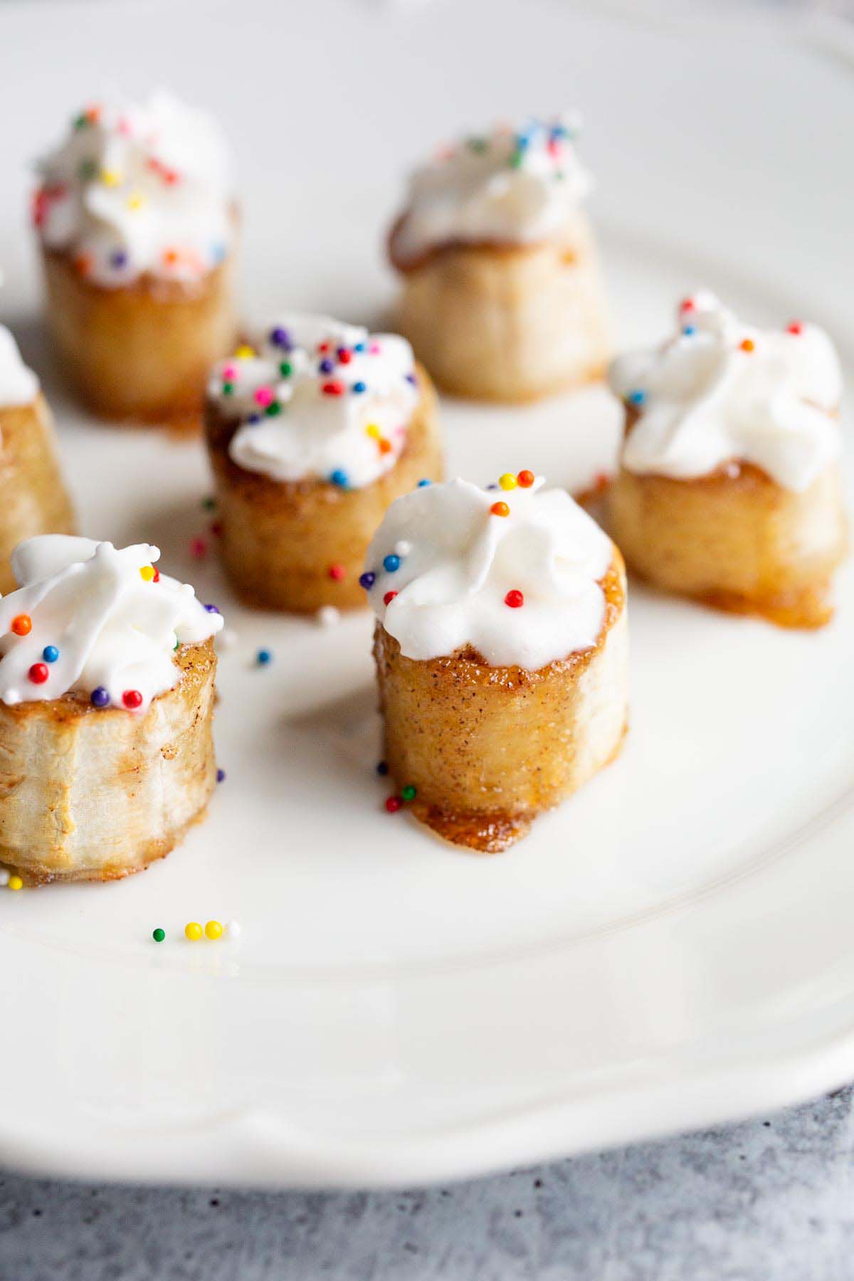 Banana bites with whipped cream and sprinkles