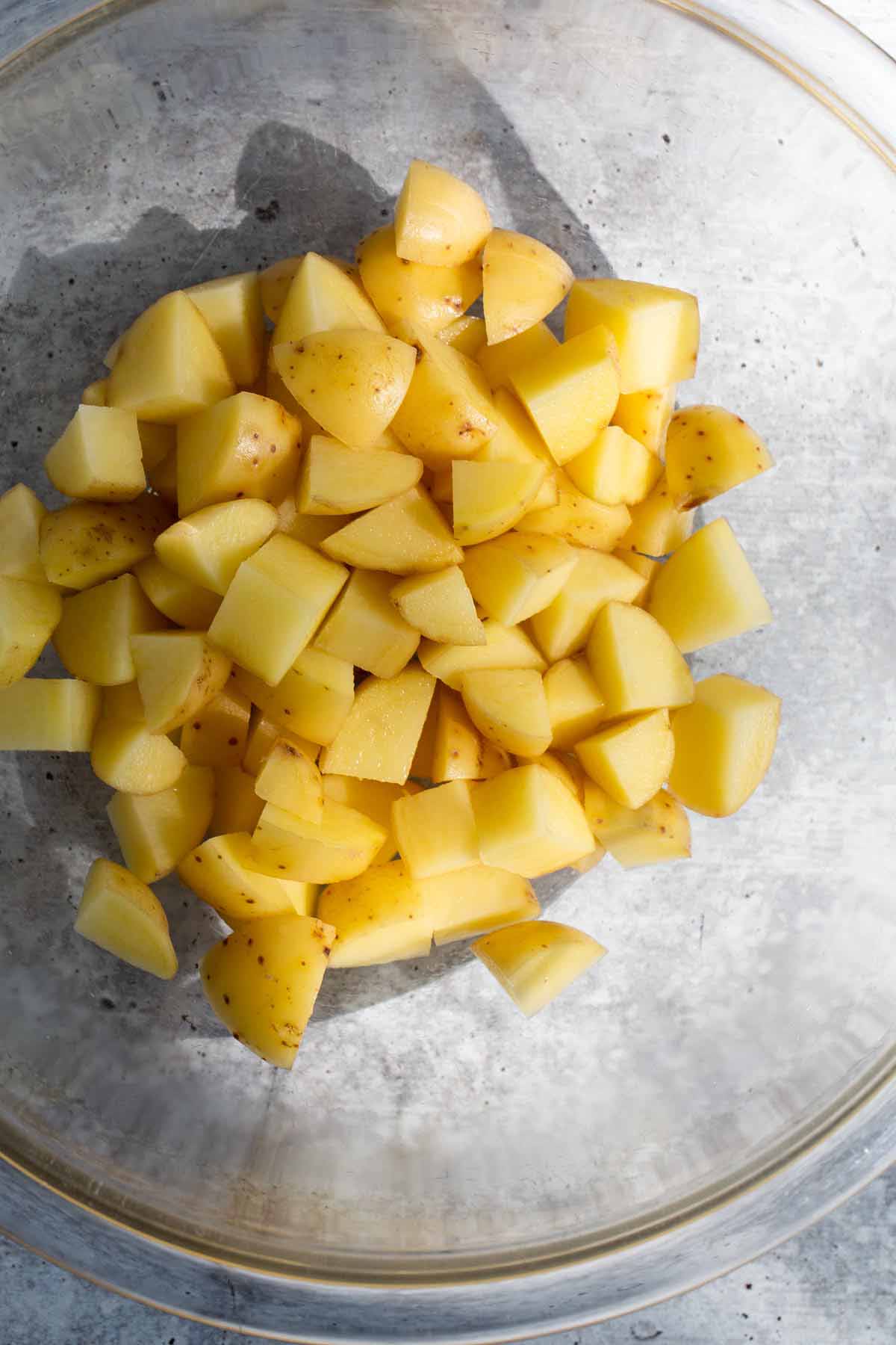 Diced potatoes in a glass bowl.