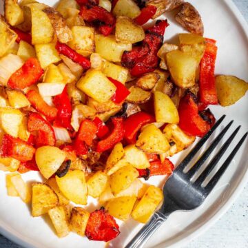 Breakfast potatoes on a white plate.