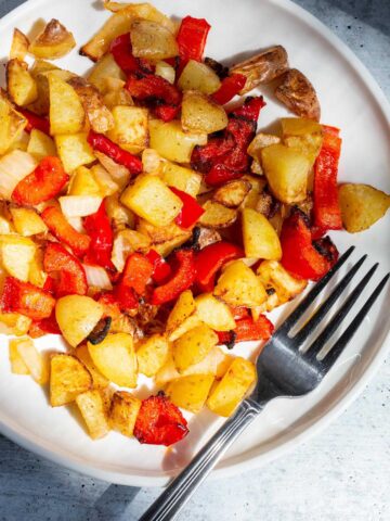 Breakfast potatoes on a white plate.