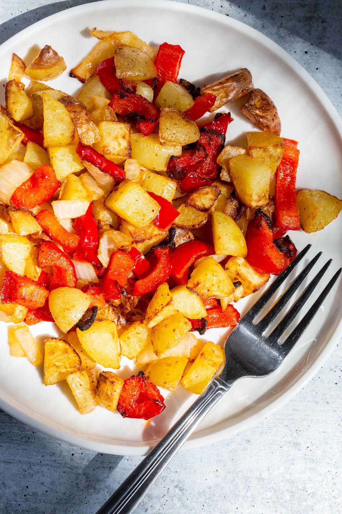 Breakfast potatoes on a white plate.