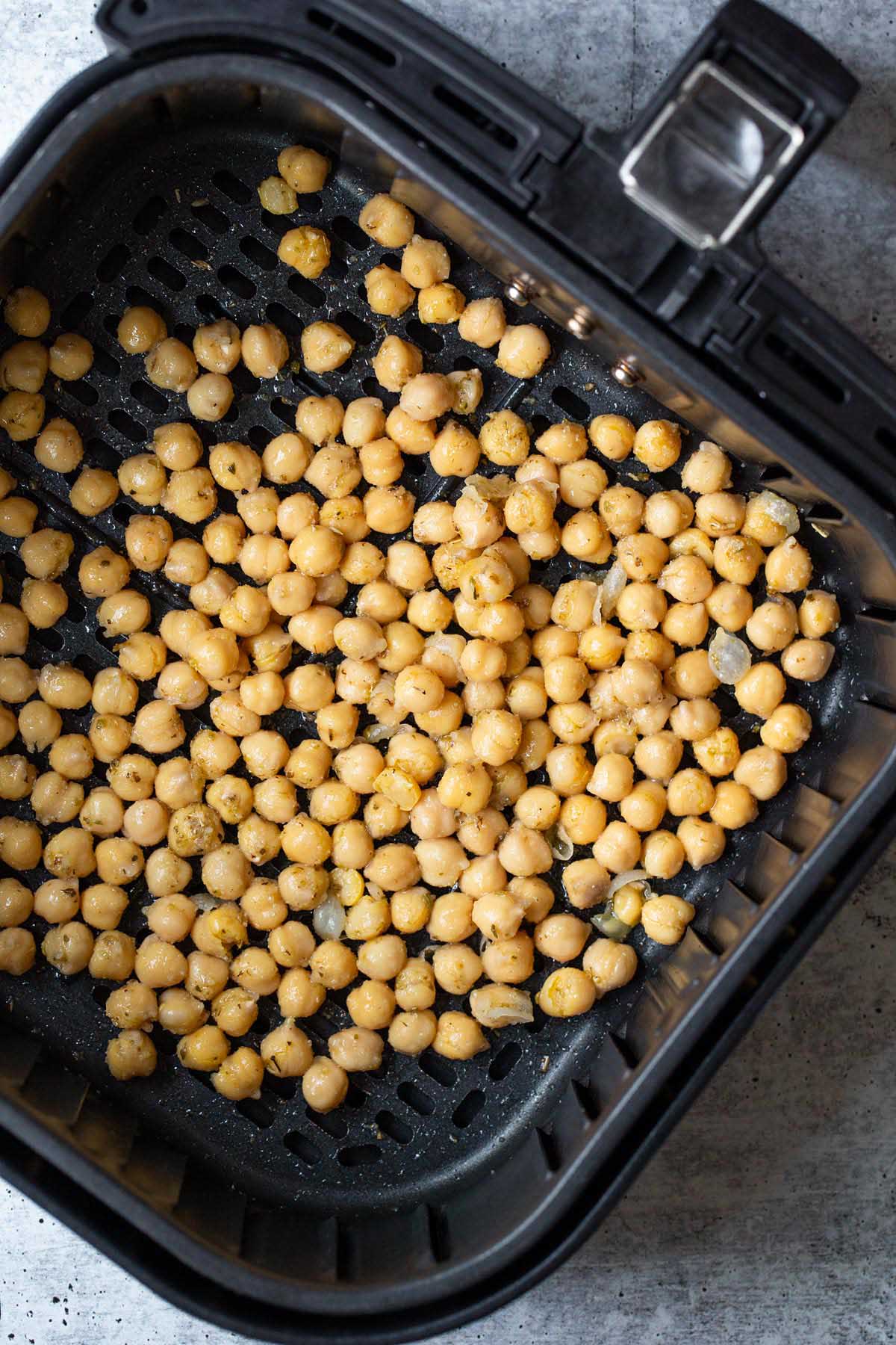 Chickpeas in air fryer basket.