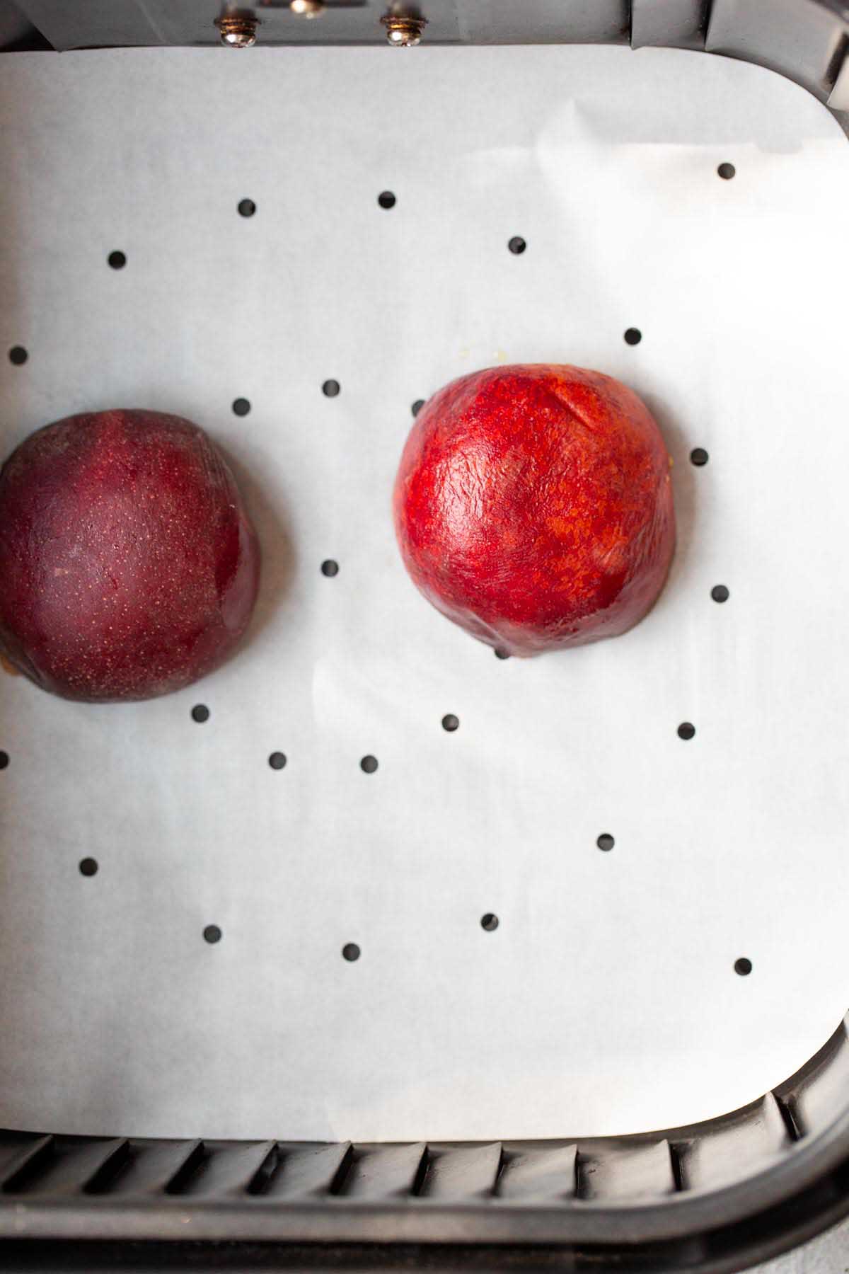 Peach halves in the air fryer.