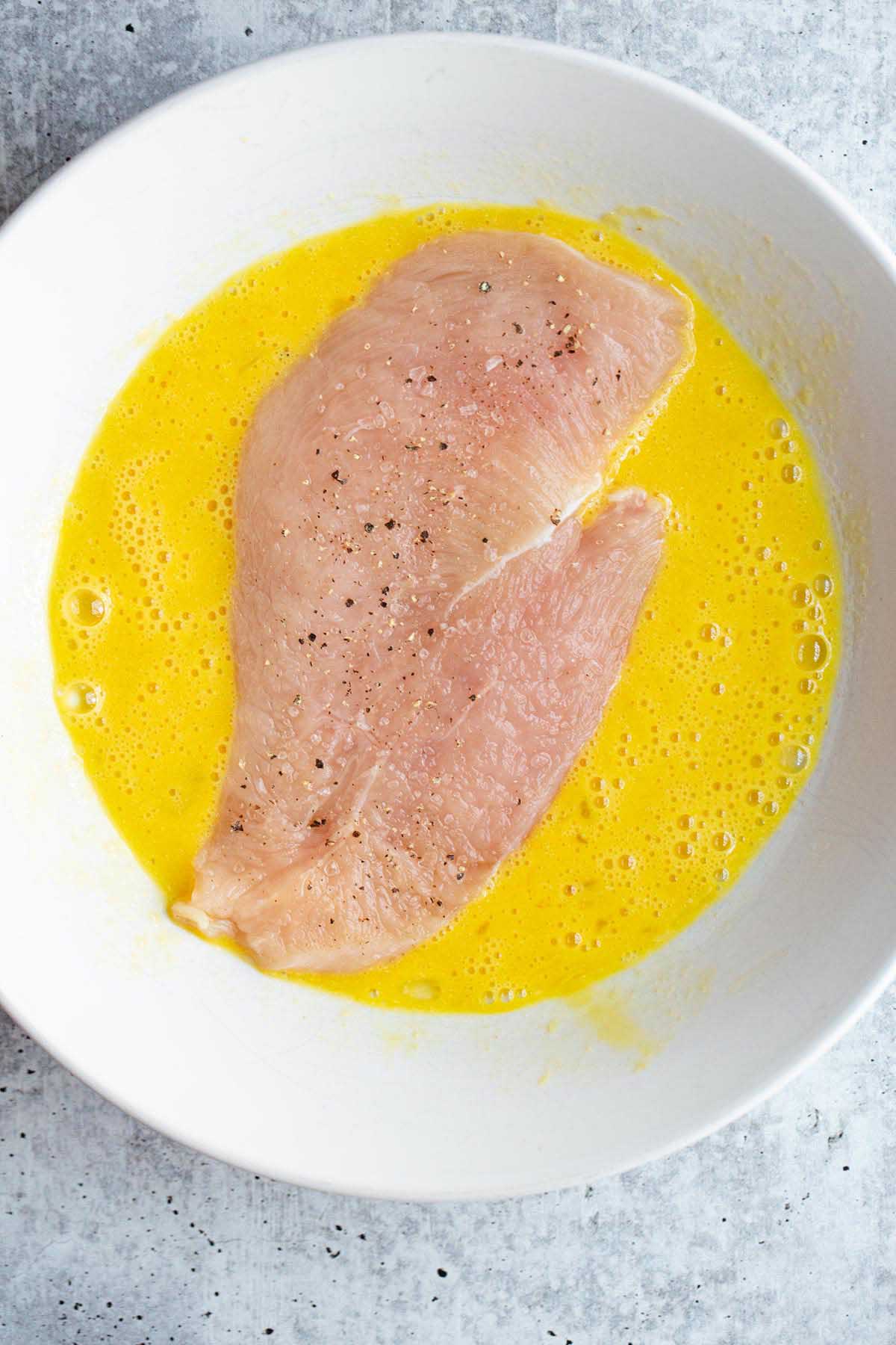 Raw chicken in an egg mixture