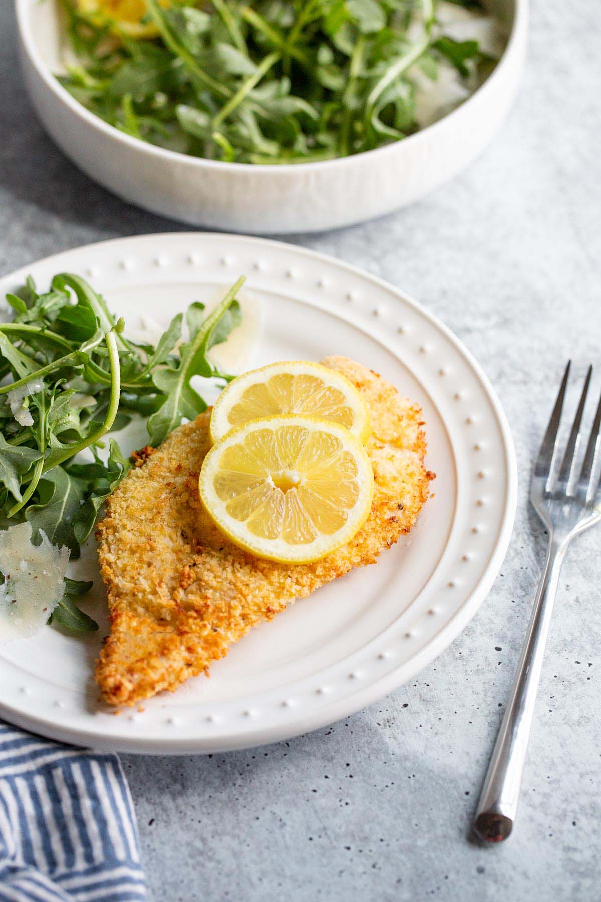 Air fried chicken cutlet with lemon slices