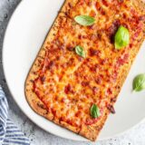 Air fryer flatbread pizza on a plate.