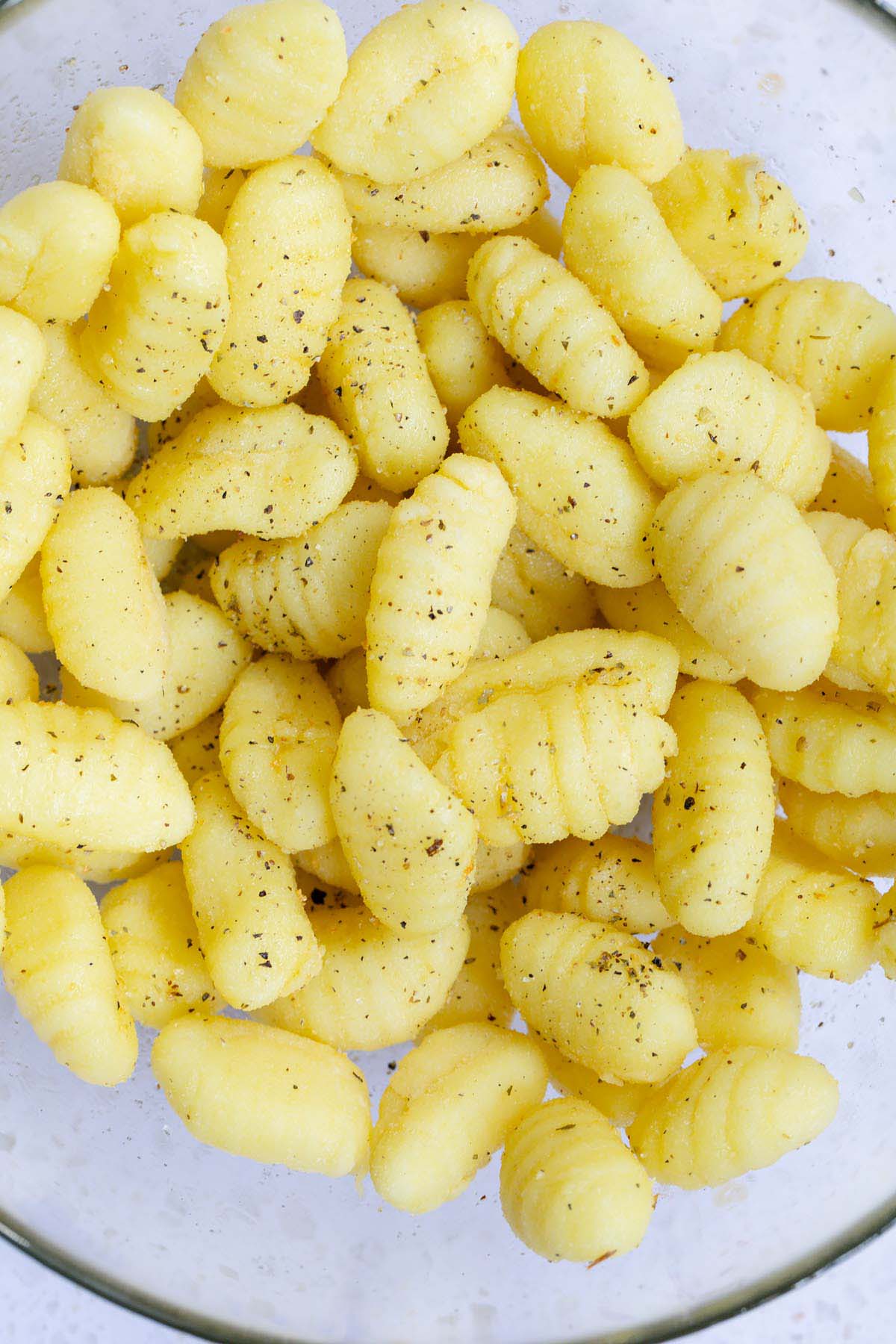 Uncooked gnocchi tossed with oil and seasonings