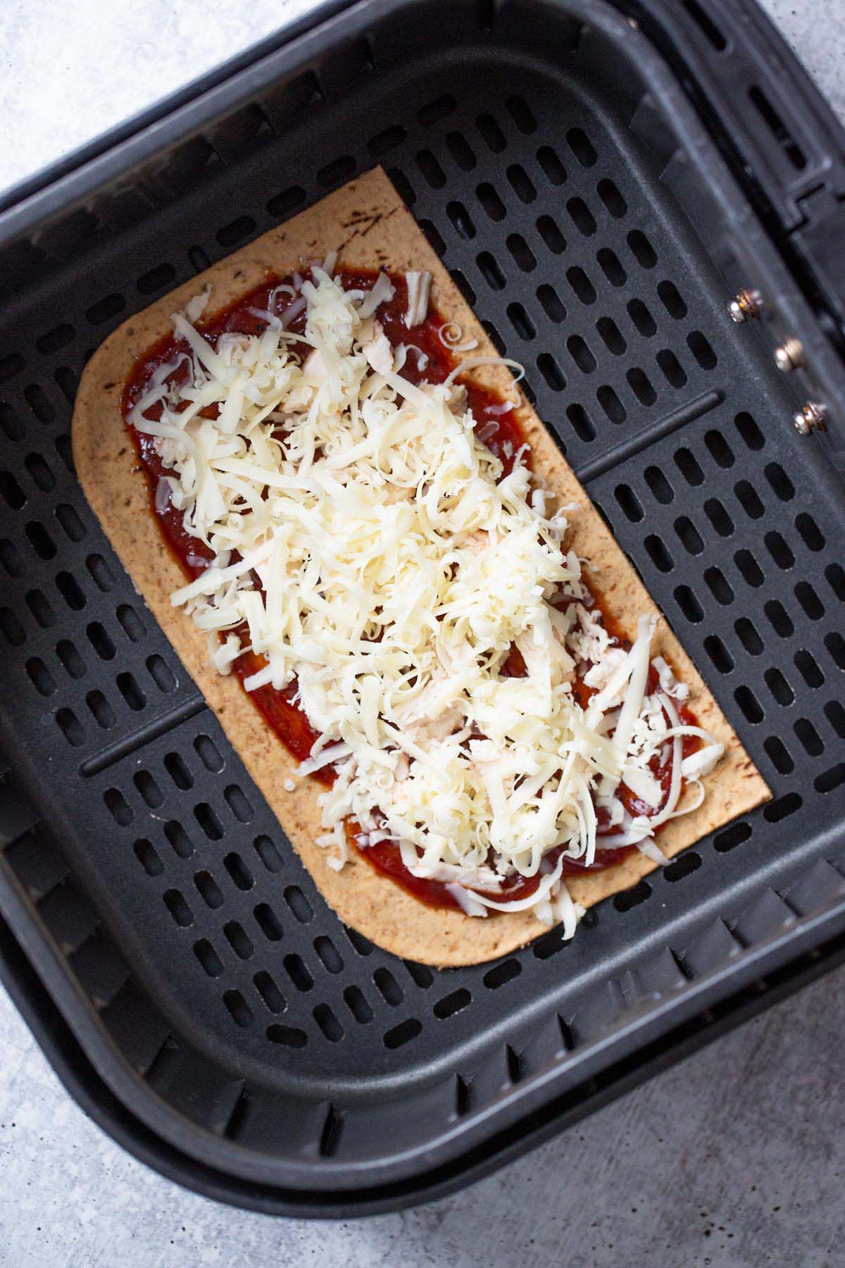 Uncooked pizza in air fryer