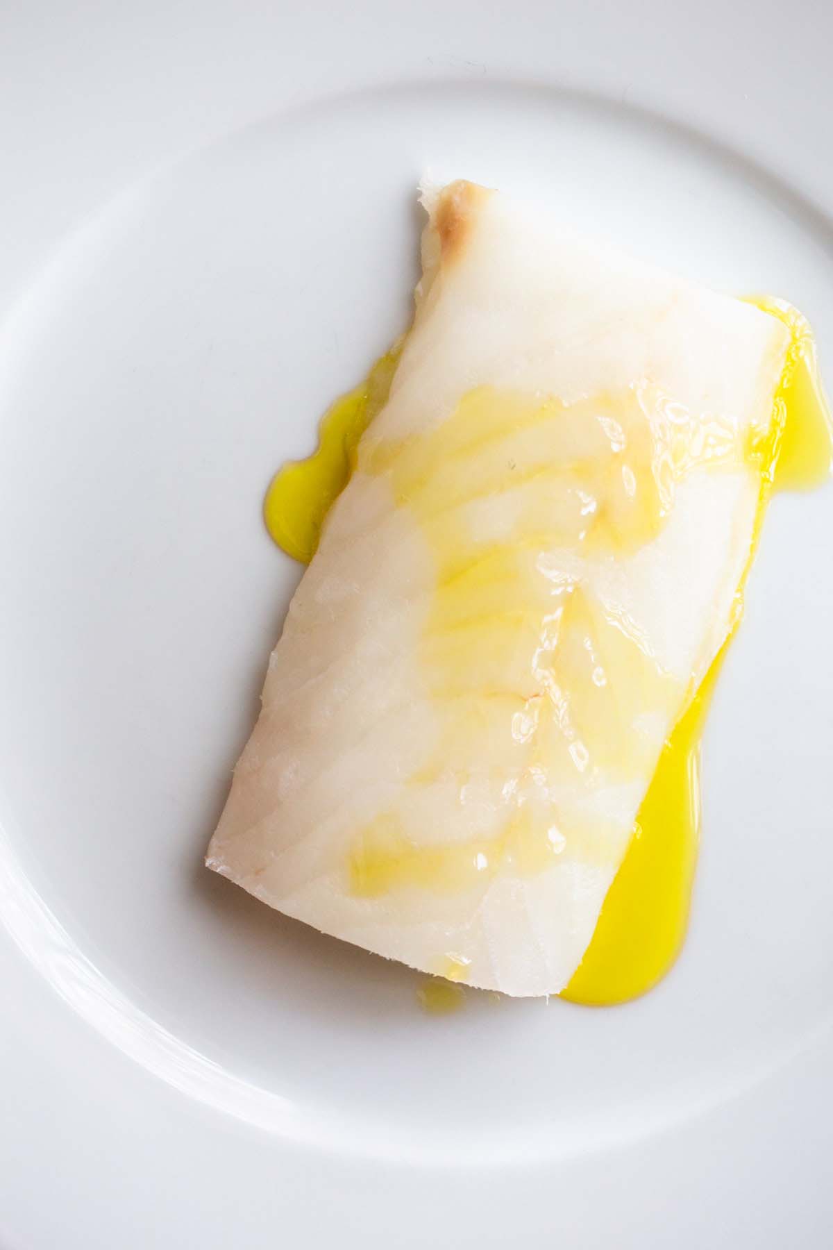 Raw cod drizzled with olive oil