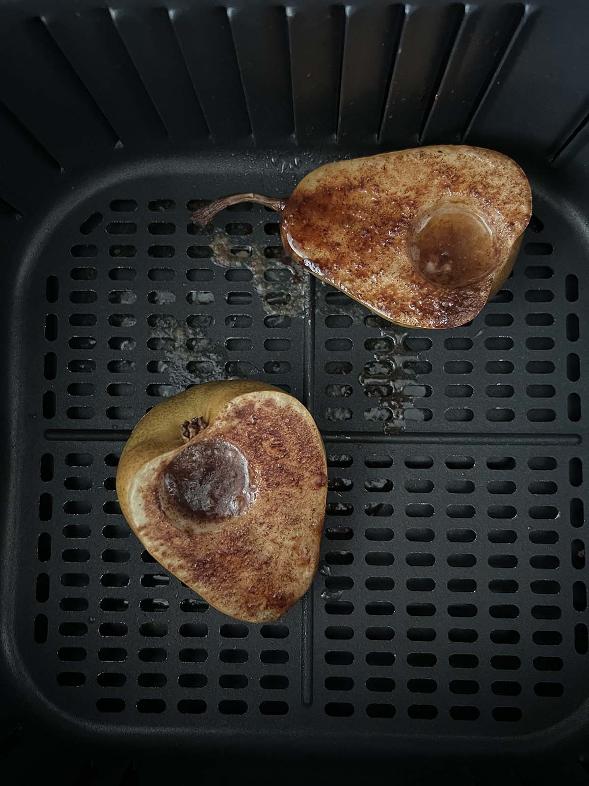 Pears in air fryer basket.