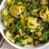 air fried brussels sprouts in a white bowl.
