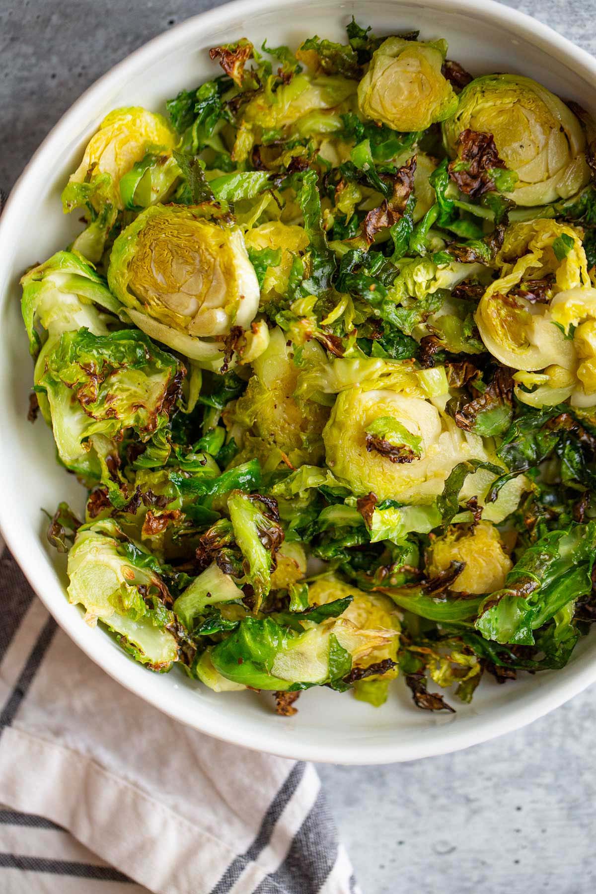 air fried brussels sprouts in a white bowl.