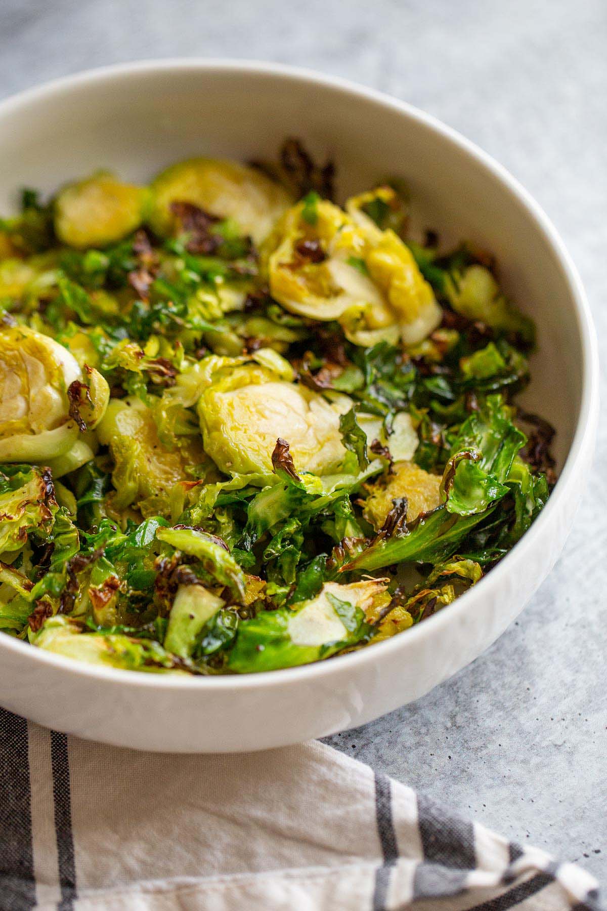 air fried brussels sprouts in a white bowl.