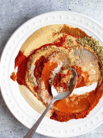 Swirling peri peri seasoning to mix