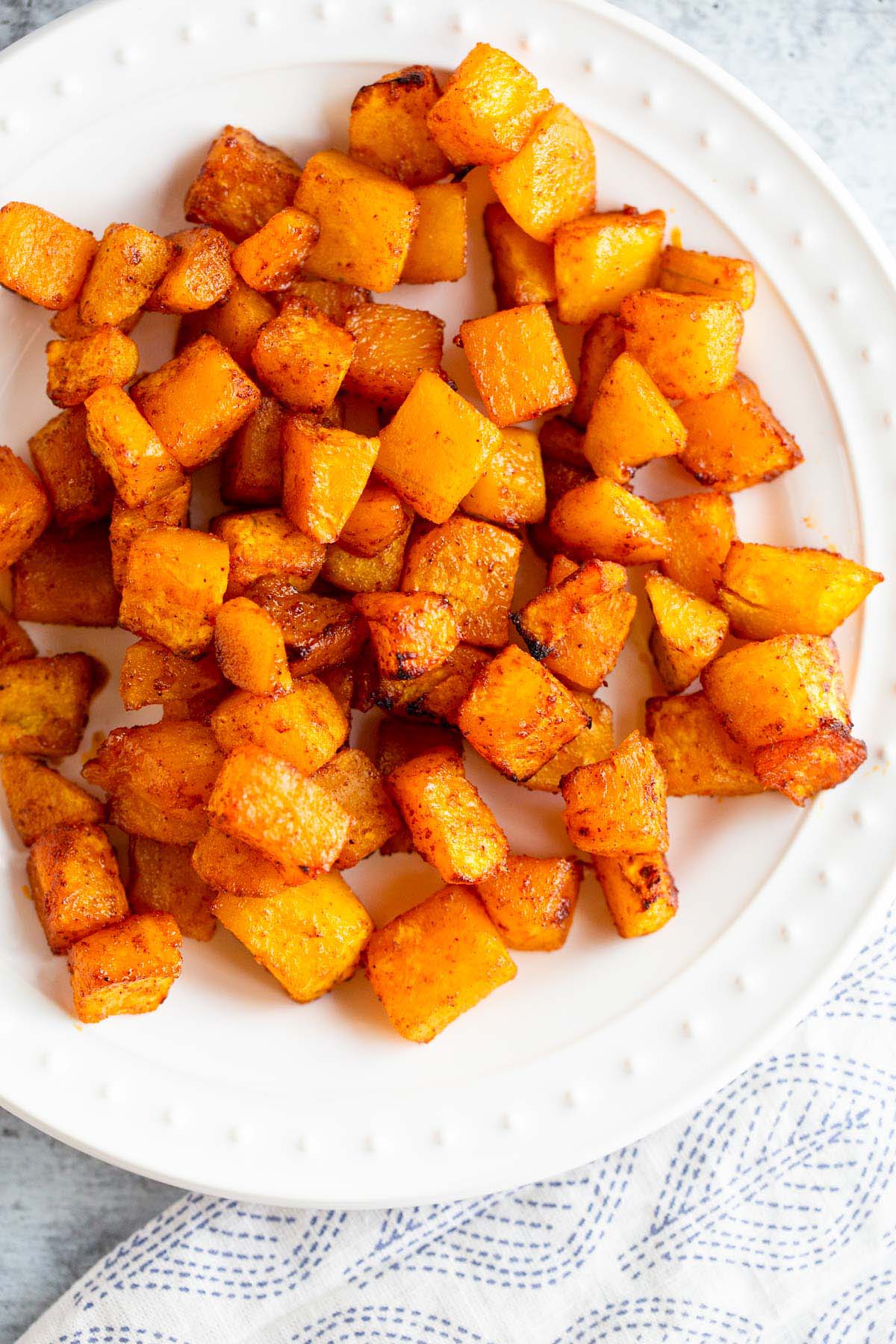 Air Fryer butternut squash on a white plate.