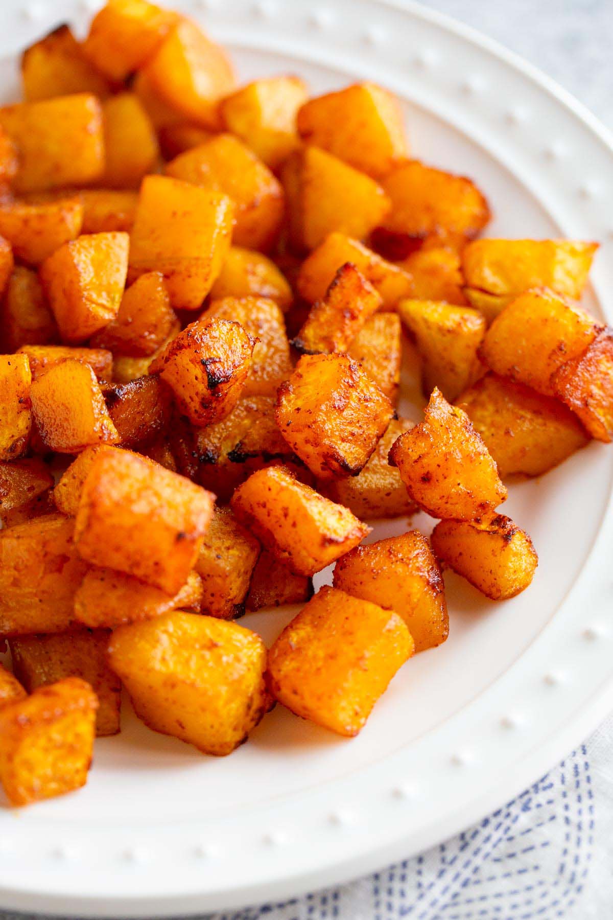 Air Fryer butternut squash on a white plate.