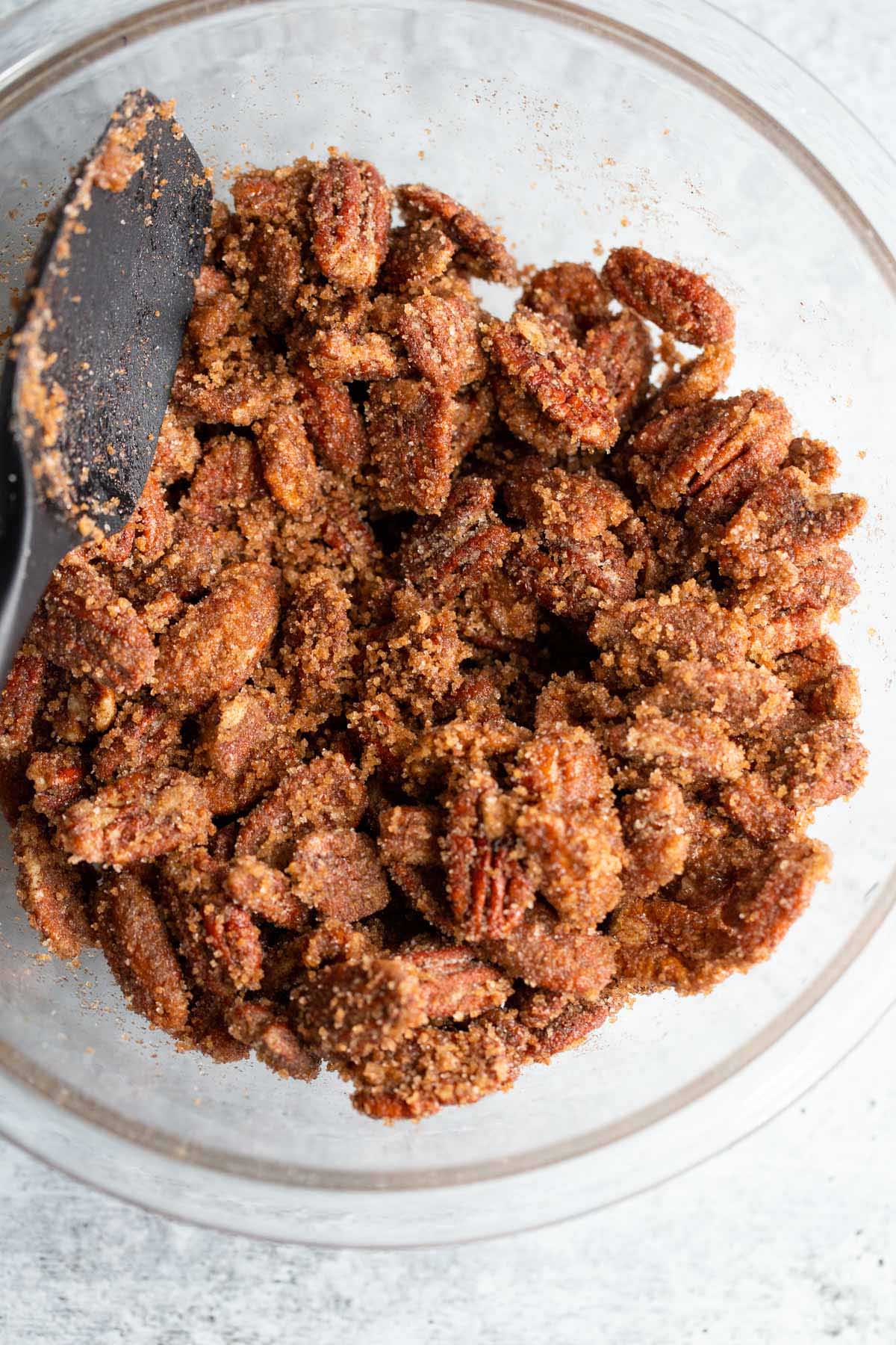 Pecans tossed in sugar coating.