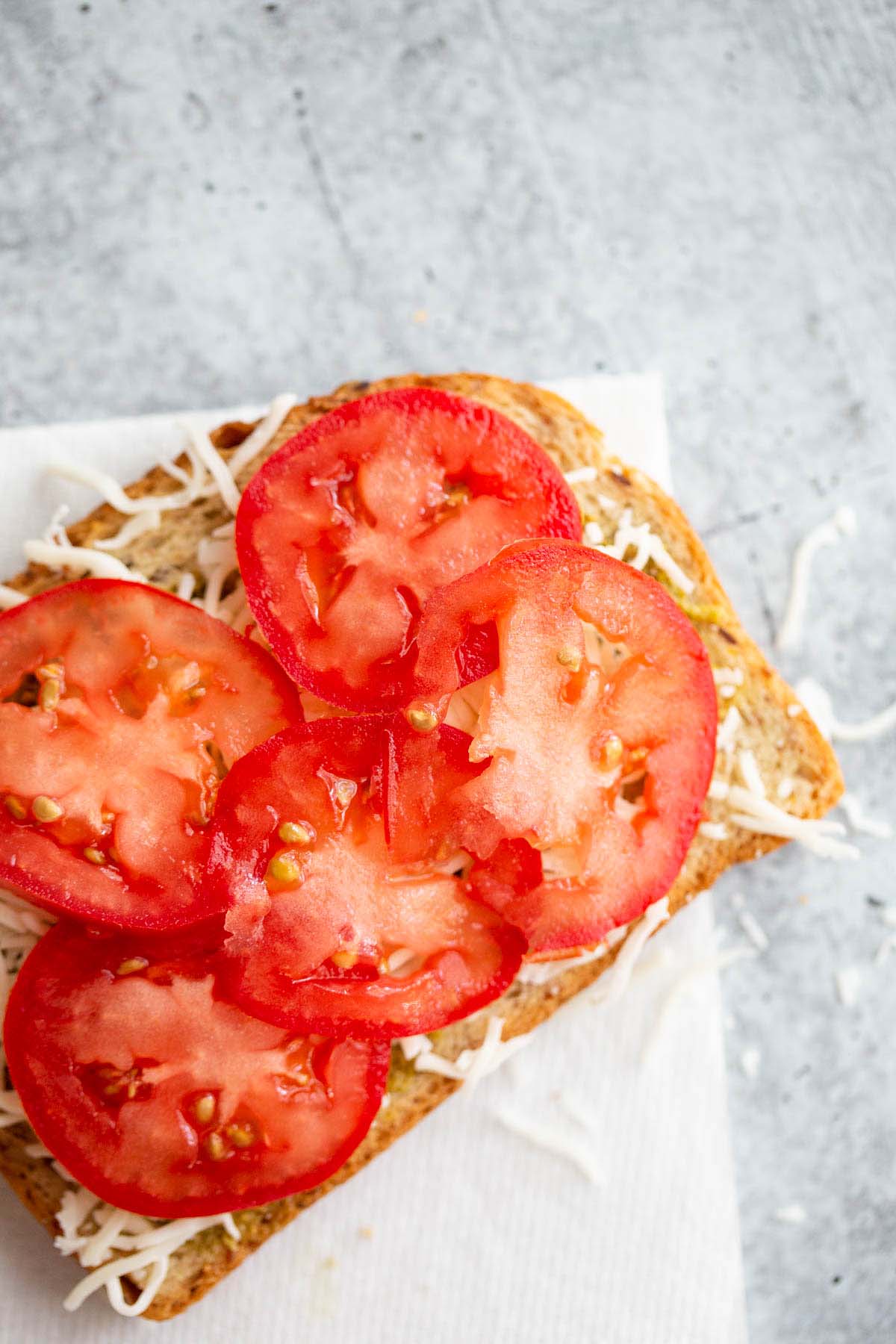 Tomato slices on a grilled cheese.