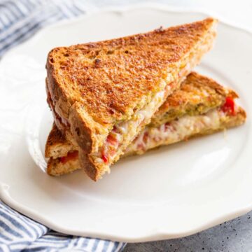 Caprese grilled cheese on a plate.