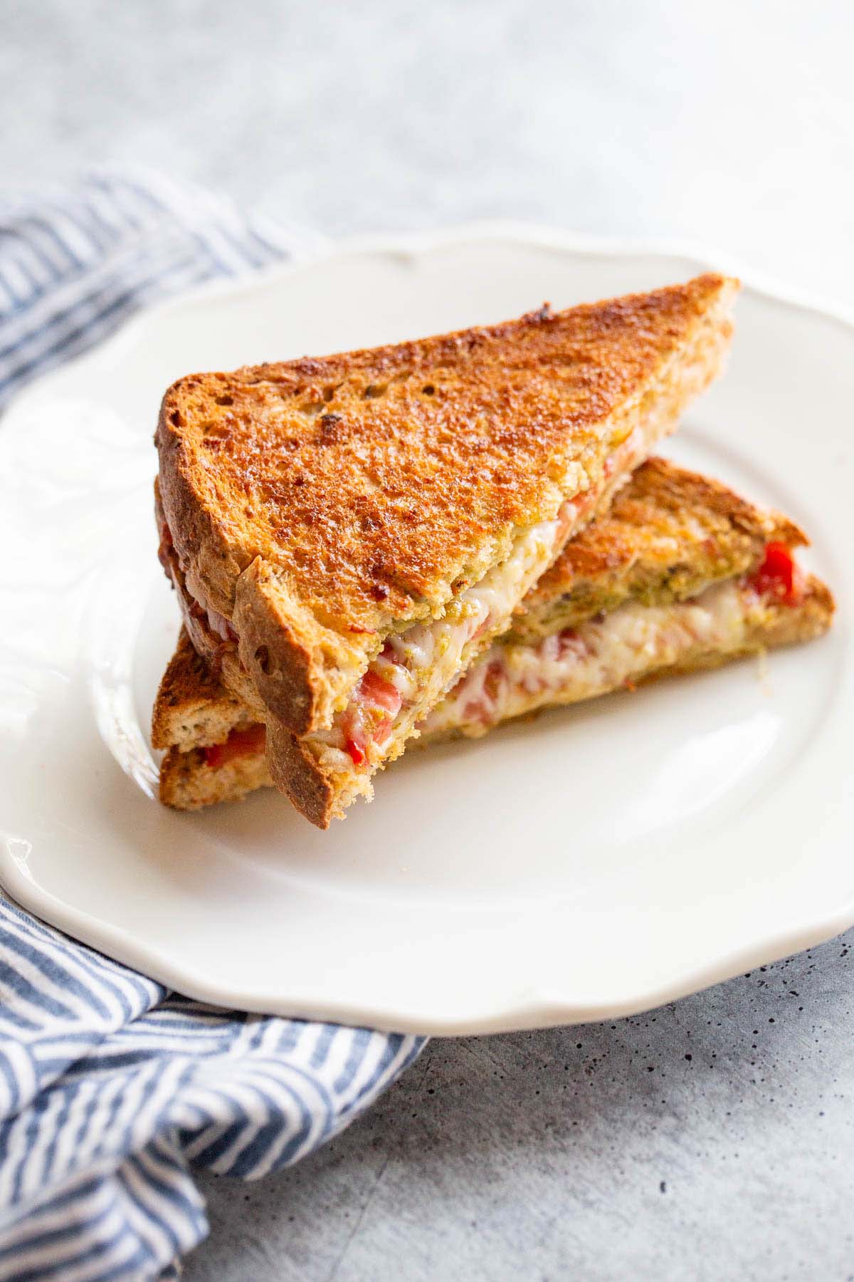 Caprese grilled cheese on a plate.