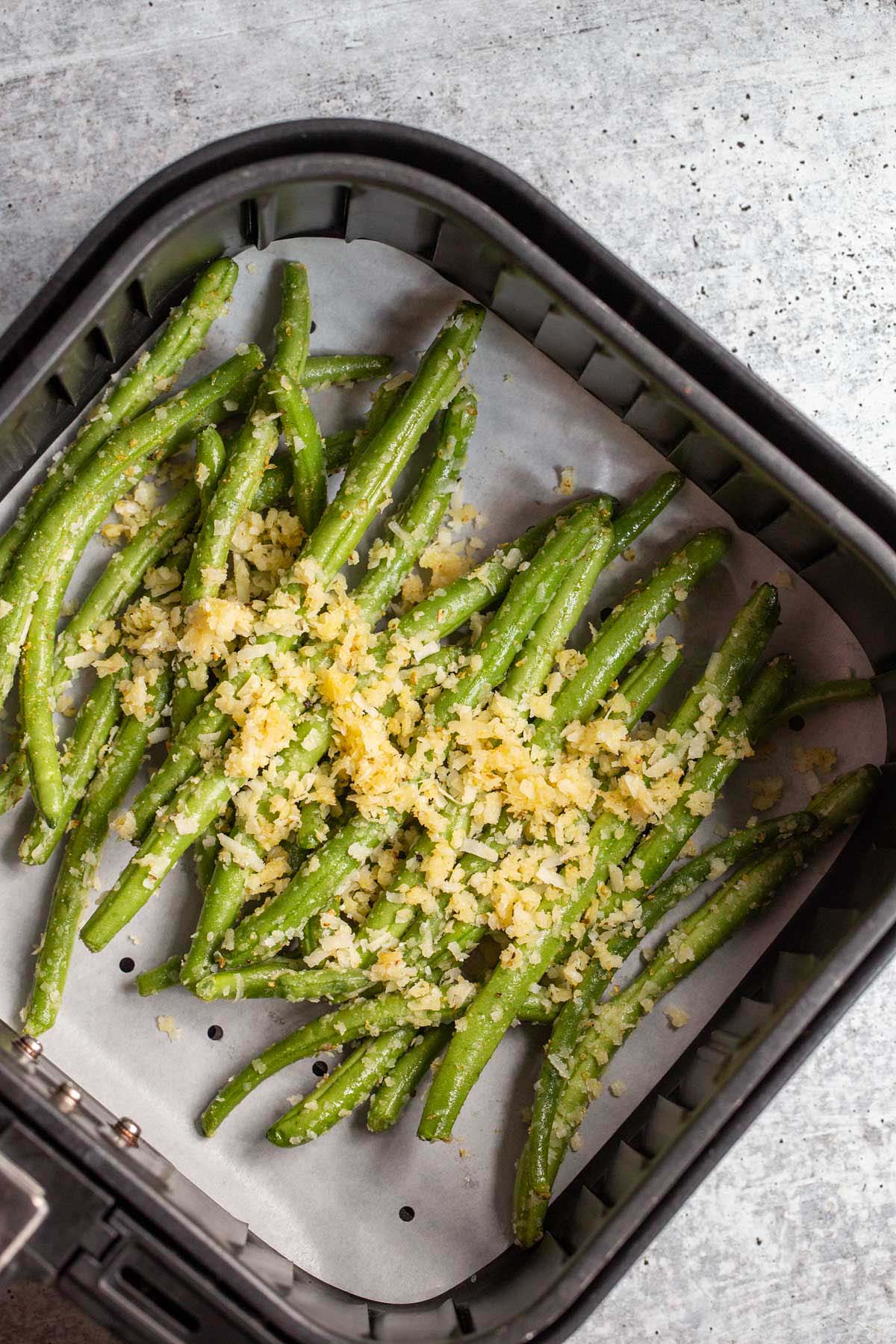 Green beans with parmesan cheese in an air fryer.