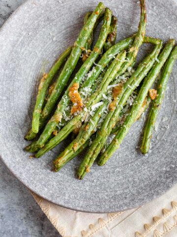 Cooked green beans on a plate.