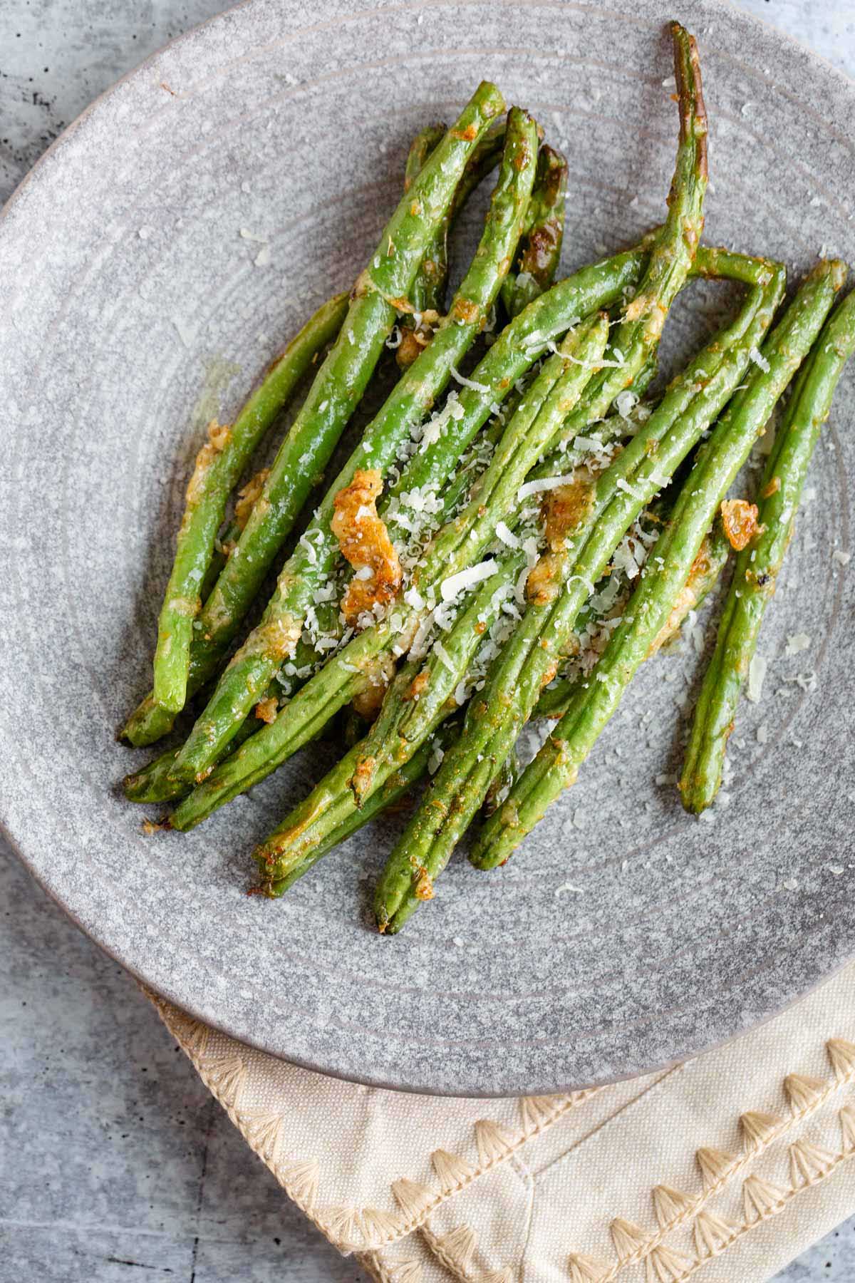 Cooked green beans on a plate.
